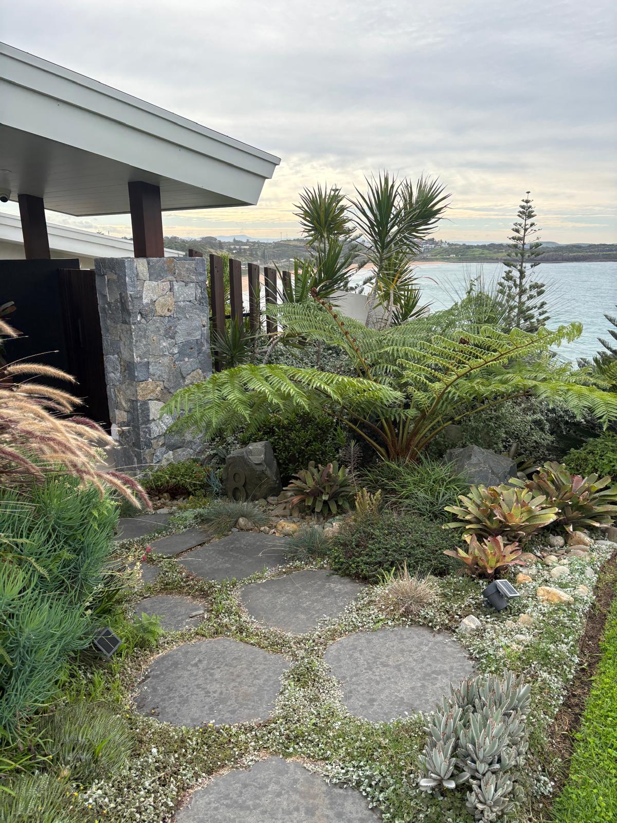Coastal garden with natural stone path, ferns and ocean outlook